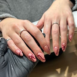 Glitter bow nail art on BIAB in rayleigh